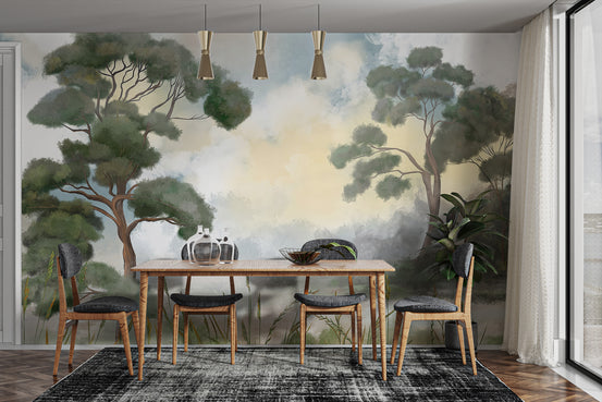 Enduring Woodland wallpaper mural of painted trees and clouds behind a wood dining table and dark chairs