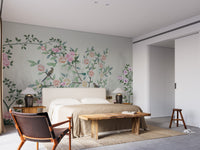 Garden Flowers Based wallpaper mural styled as a feature wall behind a dining table and chairs in green tones