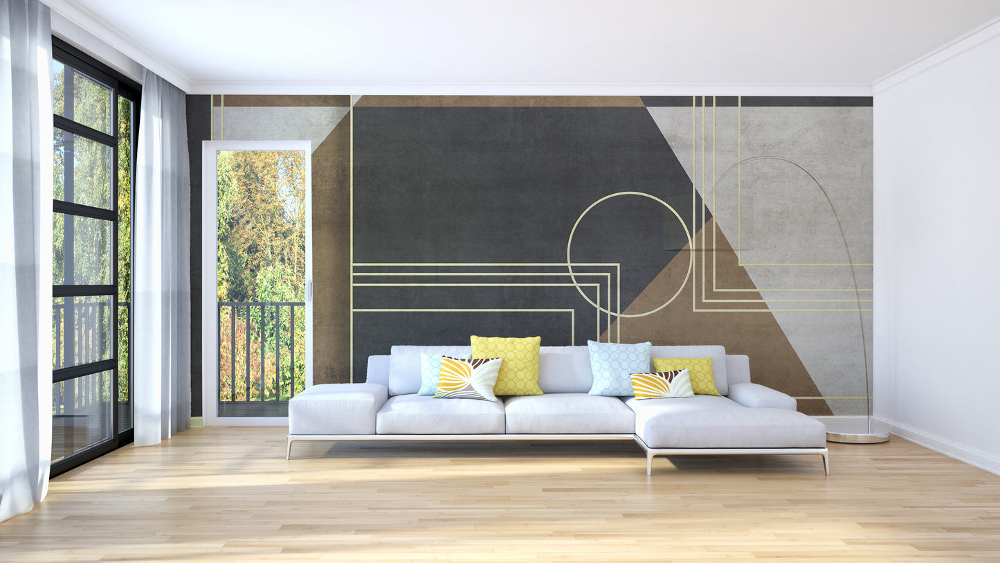 Geometric Abstraction wallpaper mural in charcoal and tan behind a white sectional sofa with yellow accent pillows