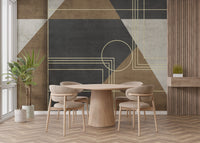 Geometric Abstraction wallpaper mural in charcoal, brown and gold lines behind a round wood dining table and beige chairs