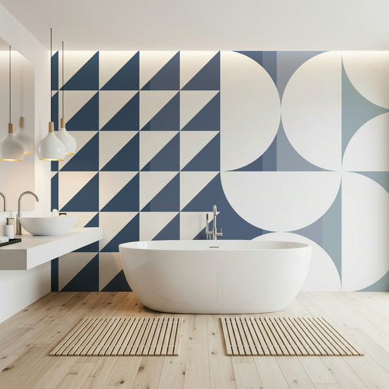Symmetrical Shift wallpaper mural in navy and cream triangles and circles behind a white freestanding bathtub