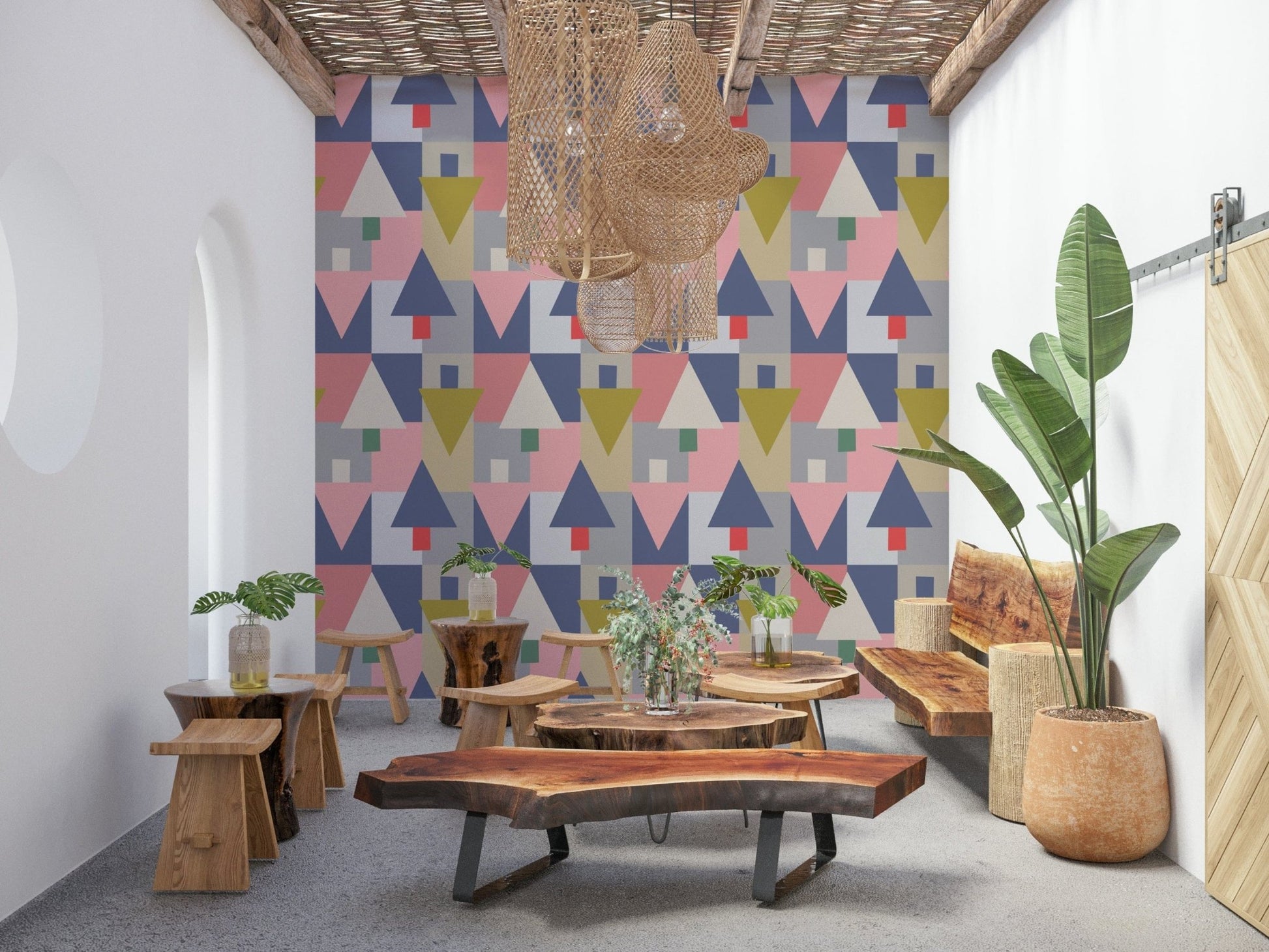 Geometric Forest Harmony wallpaper of pastel triangles in a lounge with live-edge wood benches and stools
