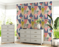 Geometric Forest Harmony wallpaper in pastel geometrics behind a grey dresser and tallboy with hydrangeas