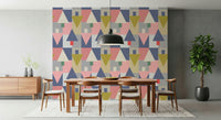 Geometric Forest Harmony wallpaper in pink and navy geometrics behind a wood dining table and black pendant