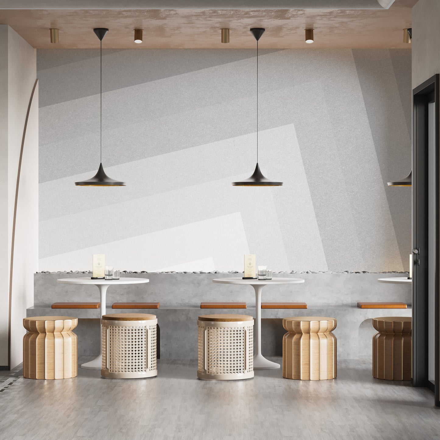 Geometric gray ombre layered wallpaper mural behind cafe tables with cane stools and black pendant lamps