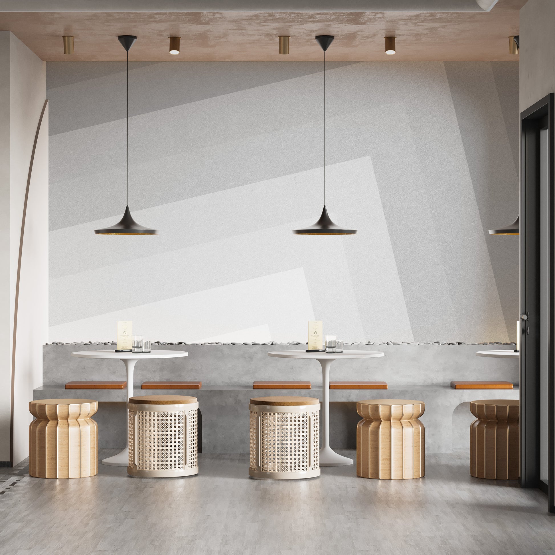 Geometric gray ombre layered wallpaper mural behind cafe tables with cane stools and black pendant lamps