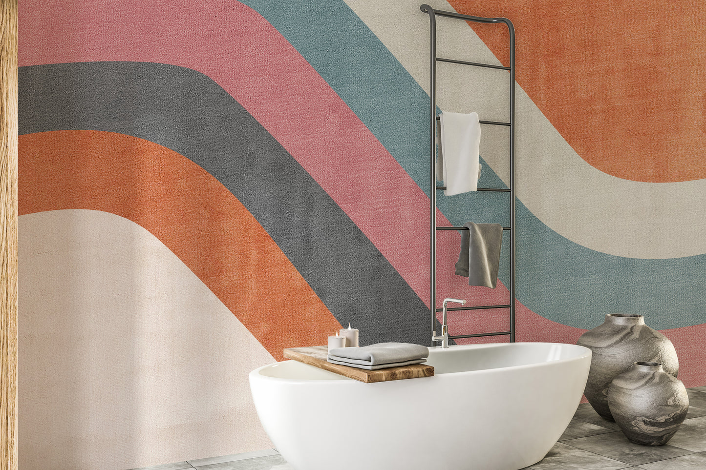 Abstract Waves wallpaper mural in orange, pink and teal in a bathroom behind a freestanding white bathtub and towel ladder