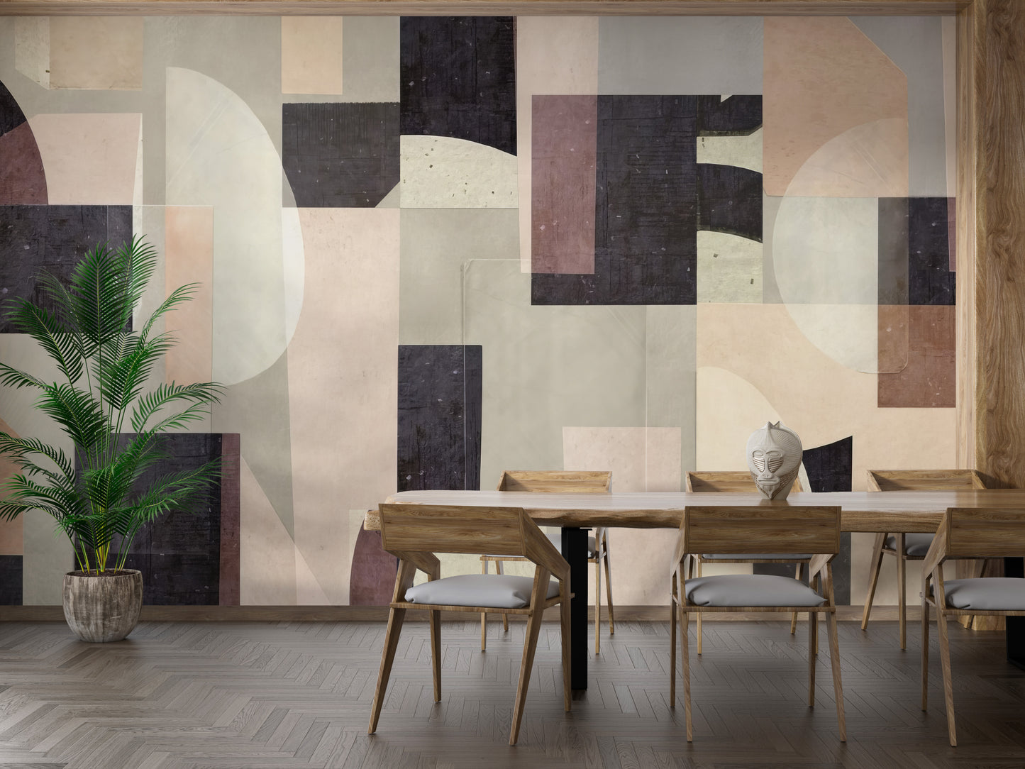 Modern Abstract wallpaper mural in soft neutral and charcoal shapes behind a wooden dining table and chairs with a tall palm