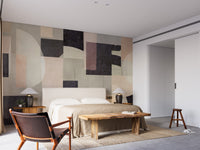 Modern Abstract wallpaper mural with muted geometric forms behind an upholstered bed and wooden bench in a calm bedroom