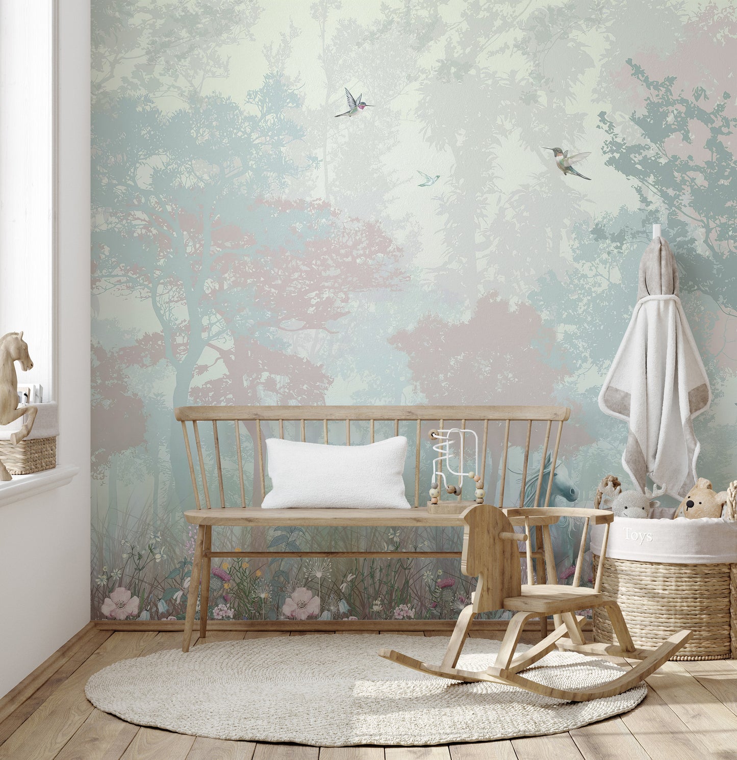 Self adhesive fairy forest mural in a nursery room with a wooden rocking horse for a sophisticated woodland look.