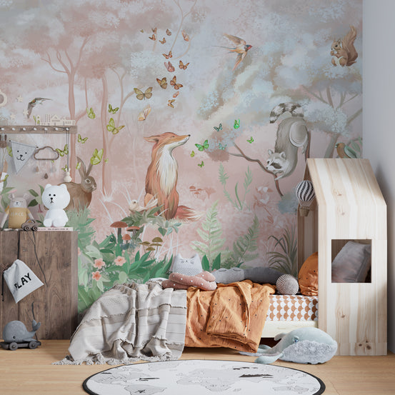 Forest Wildlife and Butterflies wall mural in blush pink with a fox beside a wooden house-frame toddler bed