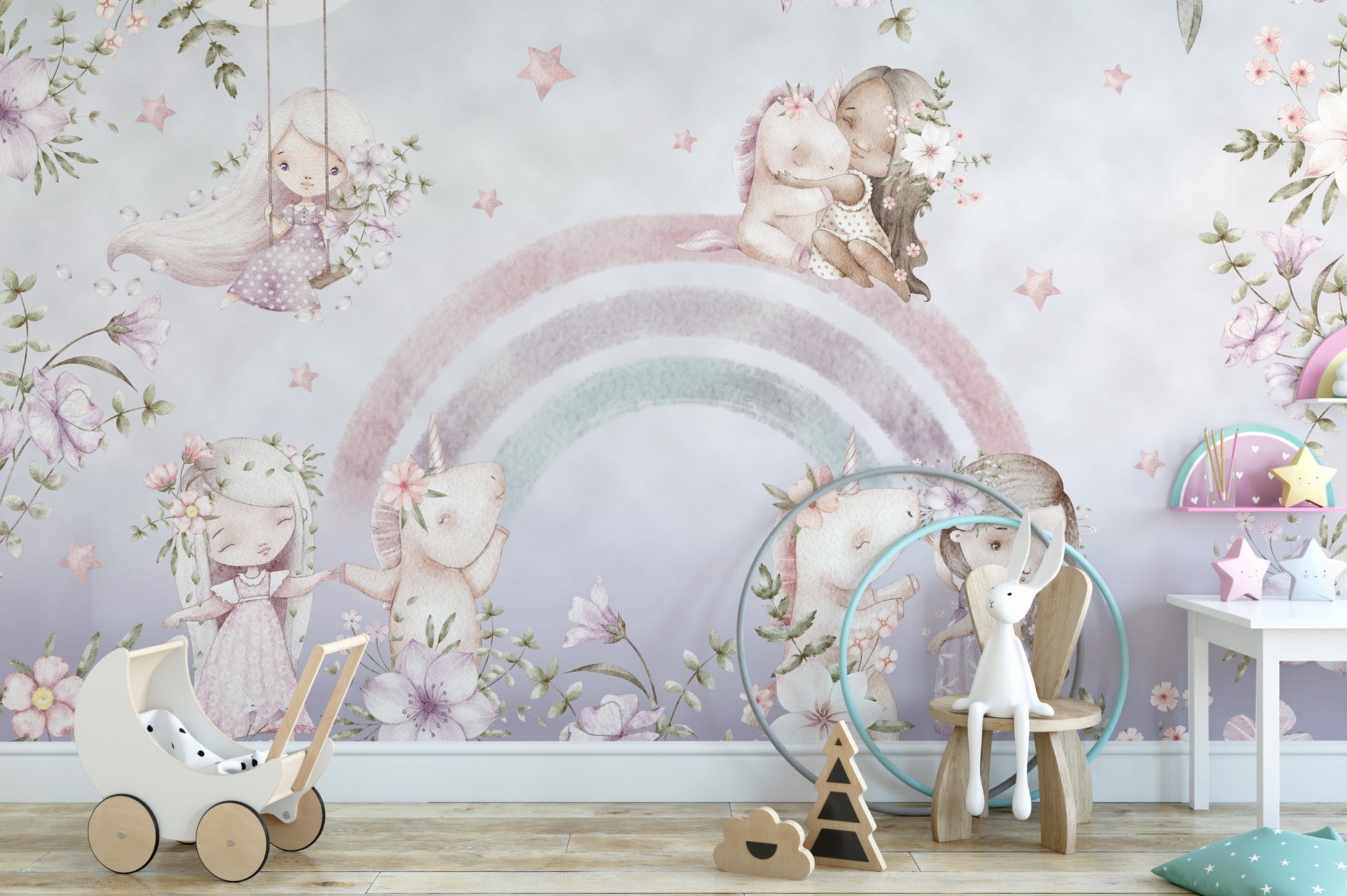 Whimsical Rainbow wall mural with watercolour fairies and unicorns behind a white toy pram in a girls nursery
