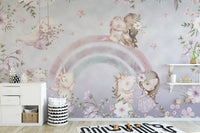 Whimsical Rainbow wall mural of pink unicorns and flowers above a white dresser in a soft pastel kids room