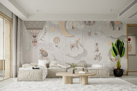Starry Circus Spectacle mural of pastel balloons and acrobats behind a beige sectional sofa and round coffee table