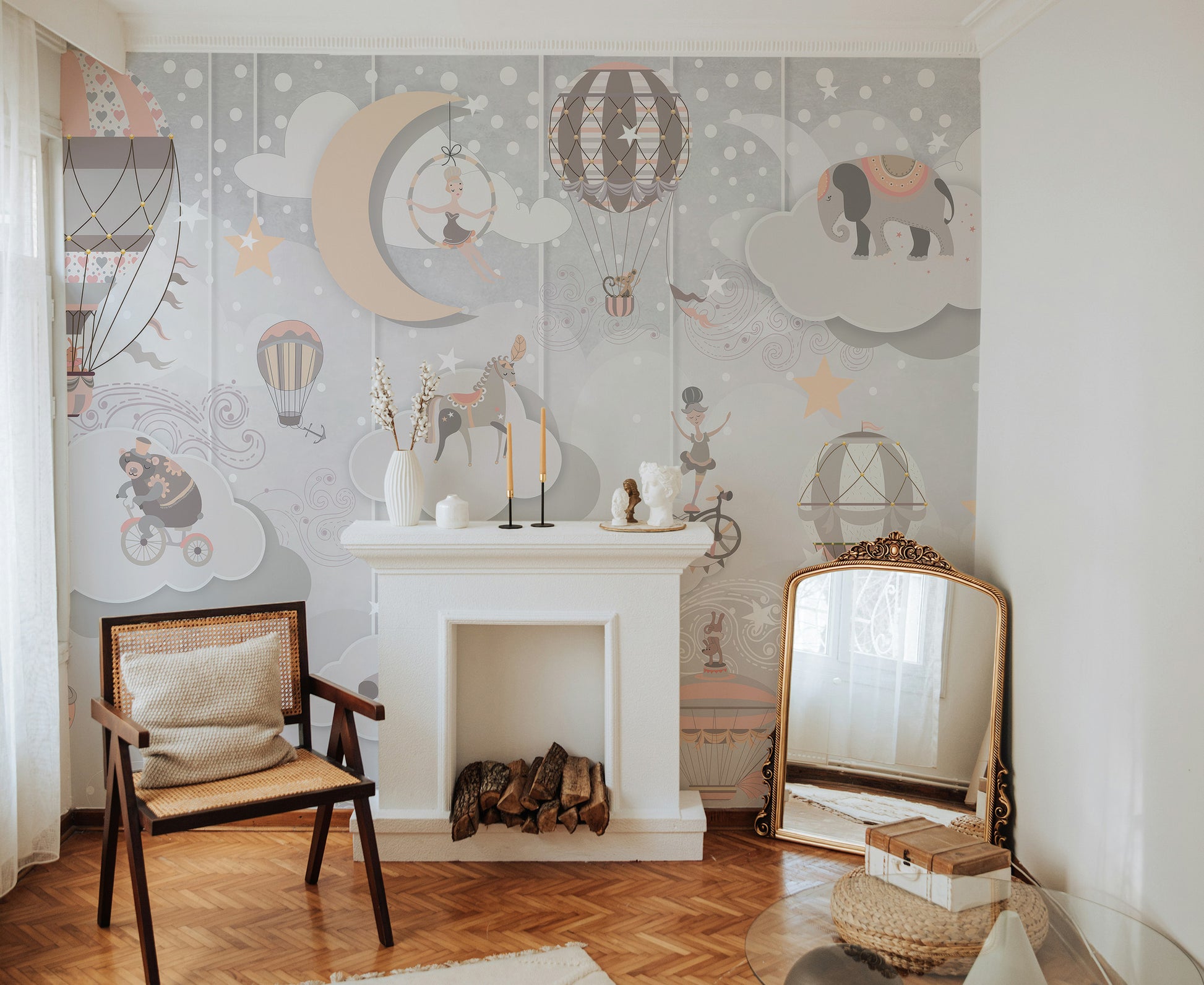 Starry Circus Spectacle mural with hot-air balloons and stars above a white fireplace mantel and cane armchair in a living room
