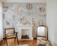 Starry Circus Spectacle mural with hot-air balloons and stars above a white fireplace mantel and cane armchair in a living room