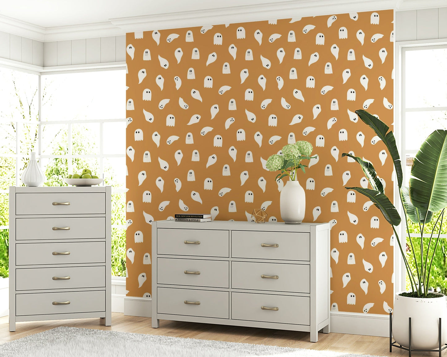 Soft, friendly ghost figures floating across a minimal spooky design.