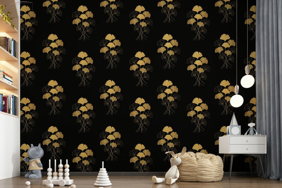 Ginkgo Luxury Gold wallpaper mural with gold ginkgo leaves on black behind a bean bag and toys in a child's room