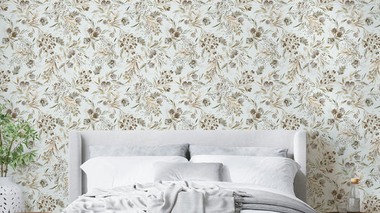 Festive Floral Minimal Plants Gold wallpaper behind an upholstered grey headboard and white bedding in a bedroom