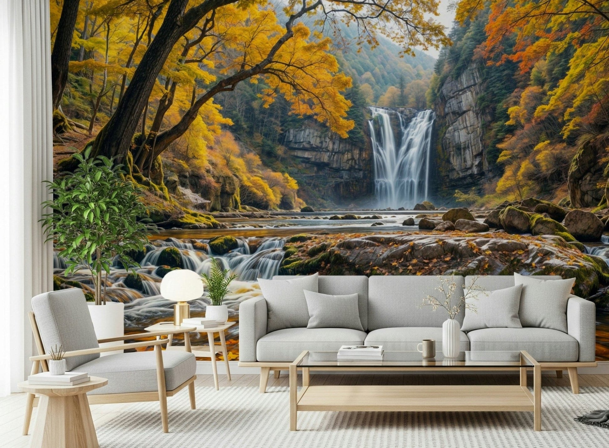Golden Falls wallpaper mural of a waterfall and autumn trees behind a gray sofa and wood armchair in a living room
