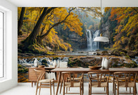 Golden Falls wallpaper mural of a waterfall and gold foliage behind a light wood dining table and wishbone chairs