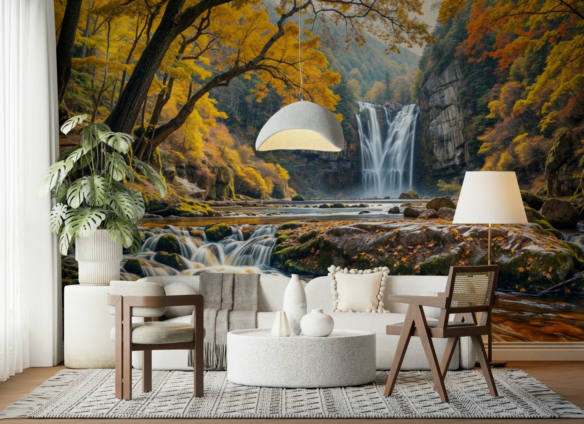 Golden Falls wallpaper mural of a waterfall and gold leaves behind a white sofa and wood chairs in a living room