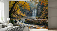 Golden Falls wallpaper mural of a waterfall and autumn forest behind a low gray bed in a bedroom