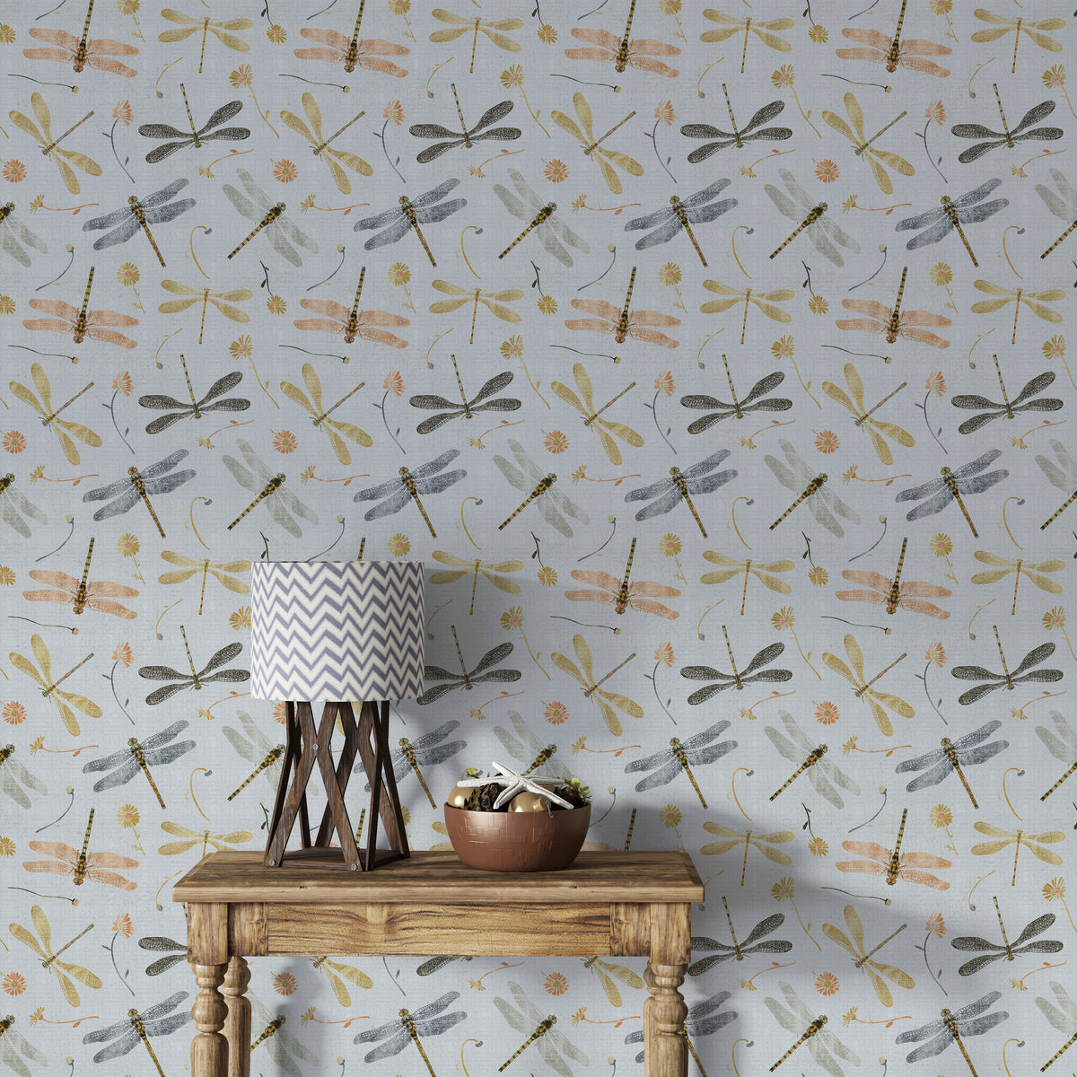 Dragonfly Damselfly Golden Gray wallpaper behind a wood console table with a chevron lamp and copper bowl