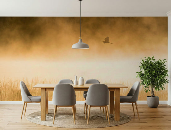 Golden Hour Flight wallpaper mural of a heron over misty golden grass at dawn behind a wood dining table and grey chairs in a dining room