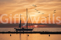 Vibrant Golden Horizon wallcovering serene golden hour water sailboat.