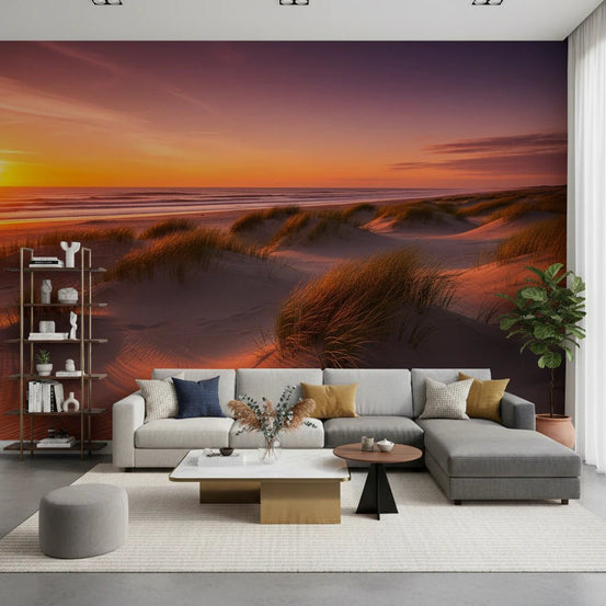 Golden Hour Dunes wallpaper mural behind a large grey sectional sofa with navy and mustard pillows in a living room