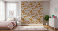 Light and airy golden leaf shapes spread across a warm-toned wallpaper for a natural look.