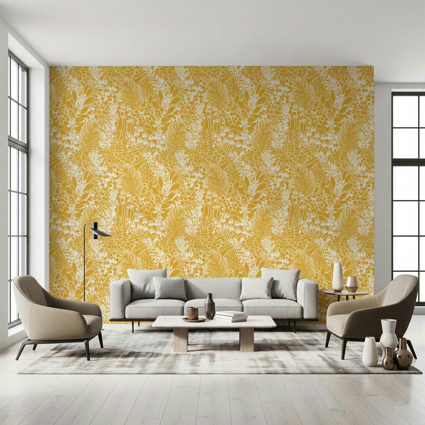 Golden Meadow Dream wallpaper in golden yellow with white leaves behind a grey sofa and beige armchairs