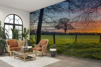 The mural is installed in a calm living room behind a simple, light-colored sofa.

