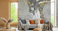 Golden Reverie wallpaper mural behind a gray sofa with terracotta pillows and a knit throw