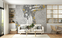 Golden Reverie wallpaper mural with gold florals behind a cream sofa by white shelving