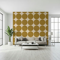 Warm neutral wallpaper with oversized ochre round shapes arranged in rows and columns