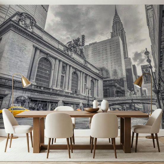 Grand Central Terminal mural behind a wood dining table, cream chairs and brass floor lamps in a dining room