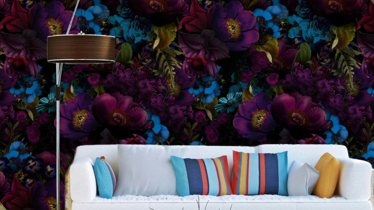 Gothic Dark Moody Florals wallpaper mural in purple and blue behind a white sofa with striped cushions