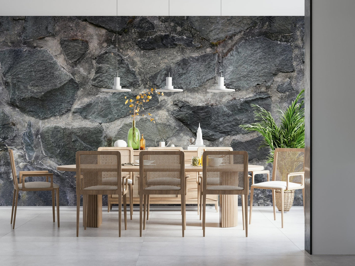 Granite Blocks wallpaper mural of grey masonry above a light wood dining table and rattan chairs
