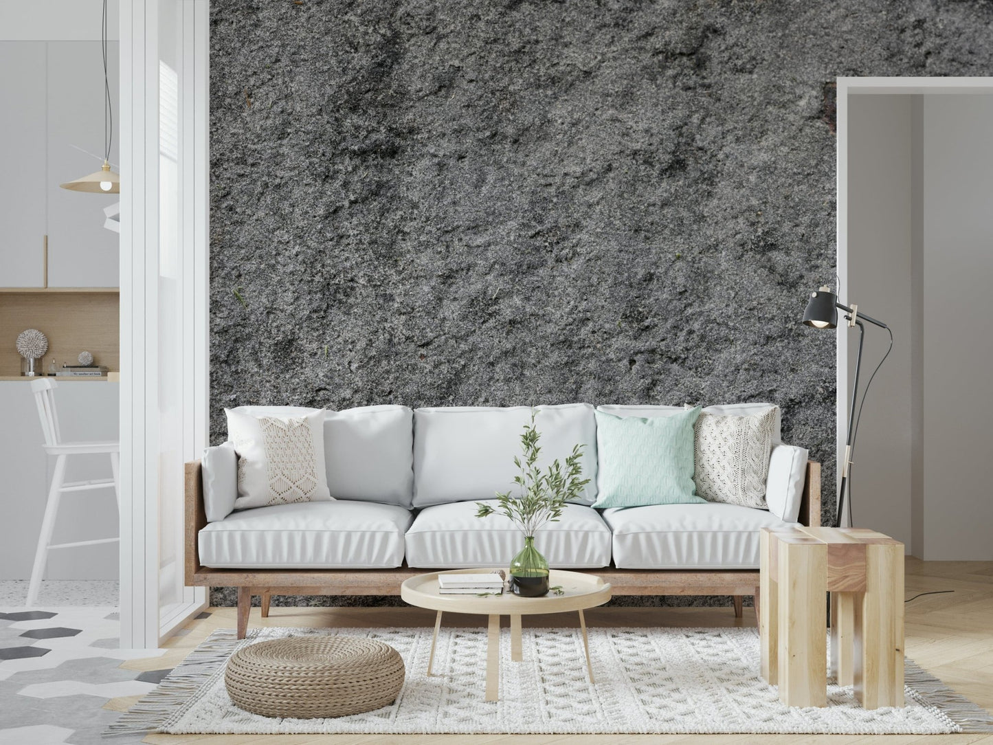 Granite Gray wallpaper mural behind a white sofa with a mint pillow and round wood coffee table