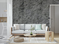 Granite Gray wallpaper mural behind a white sofa with a mint pillow and round wood coffee table