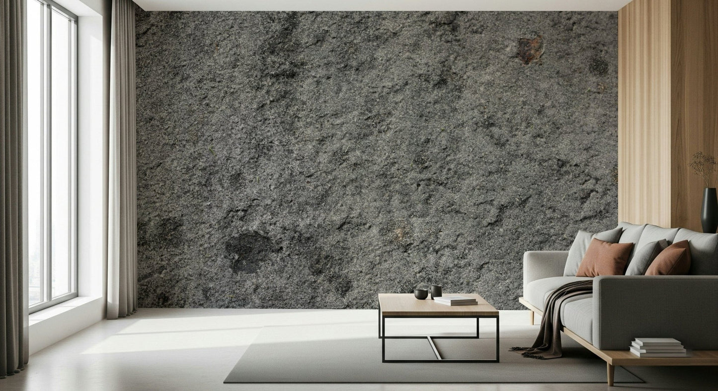 Granite Gray wallpaper mural behind a grey sofa and metal-framed coffee table beside tall windows