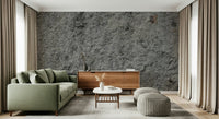 Granite Gray wallpaper mural behind a green sofa and walnut sideboard with two grey poufs