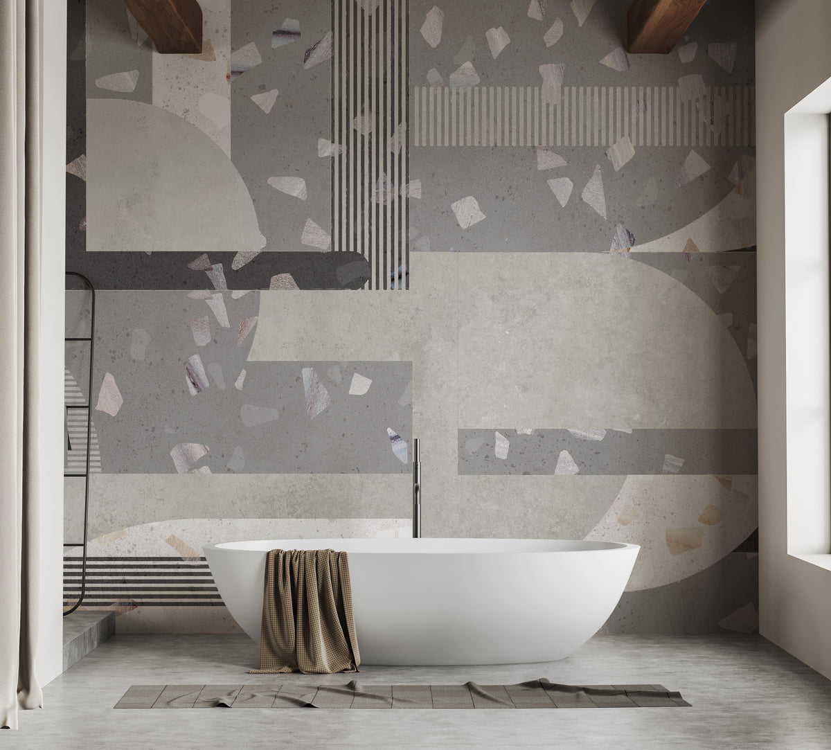 Gray Cement terrazzo tile wallpaper mural with speckled geometric blocks behind a freestanding bathtub in a bathroom