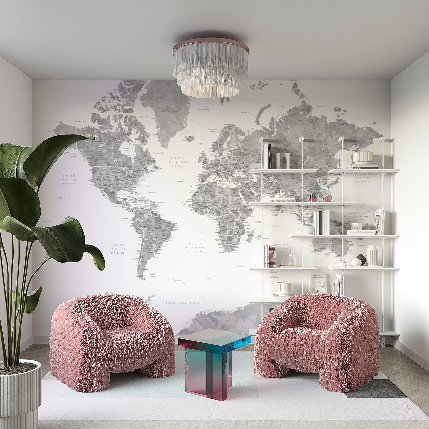 Gray Watercolor World Map wallpaper mural in soft gray behind two pink fluffy armchairs in a lounge