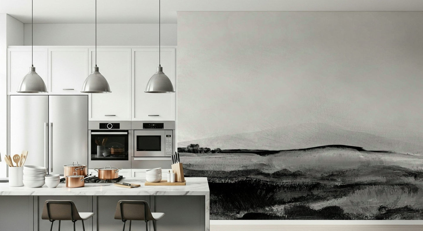 Grayscale Hills wallpaper mural in a modern kitchen with a marble island, copper pots and steel pendant lights