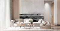 Grayscale Hills wallpaper mural behind a beige sofa with live-edge wood coffee tables and a cream beanbag chair