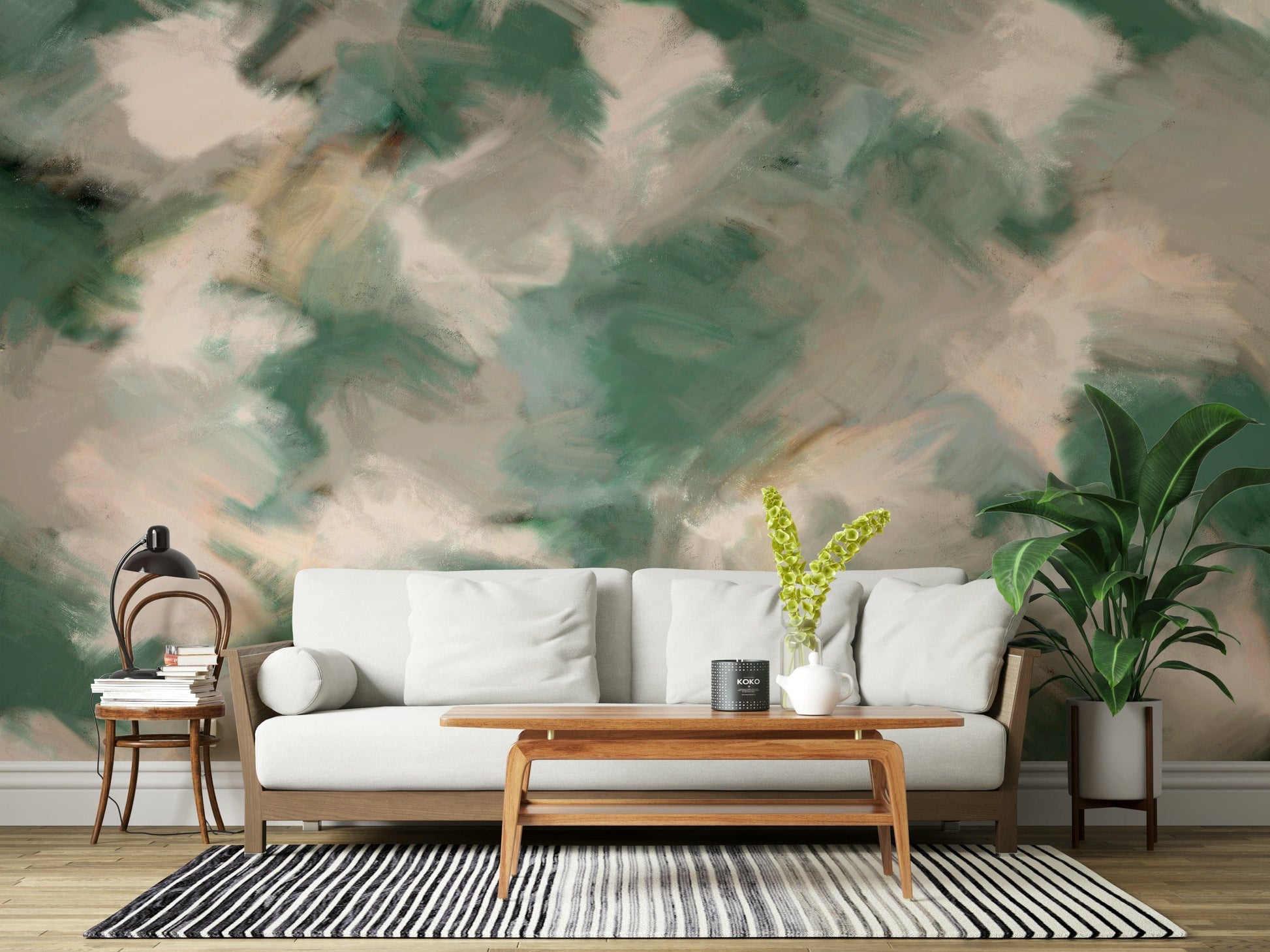 Ethereal Brushstrokes wallpaper mural in green and cream behind a cream sofa with wood coffee table and monstera plant