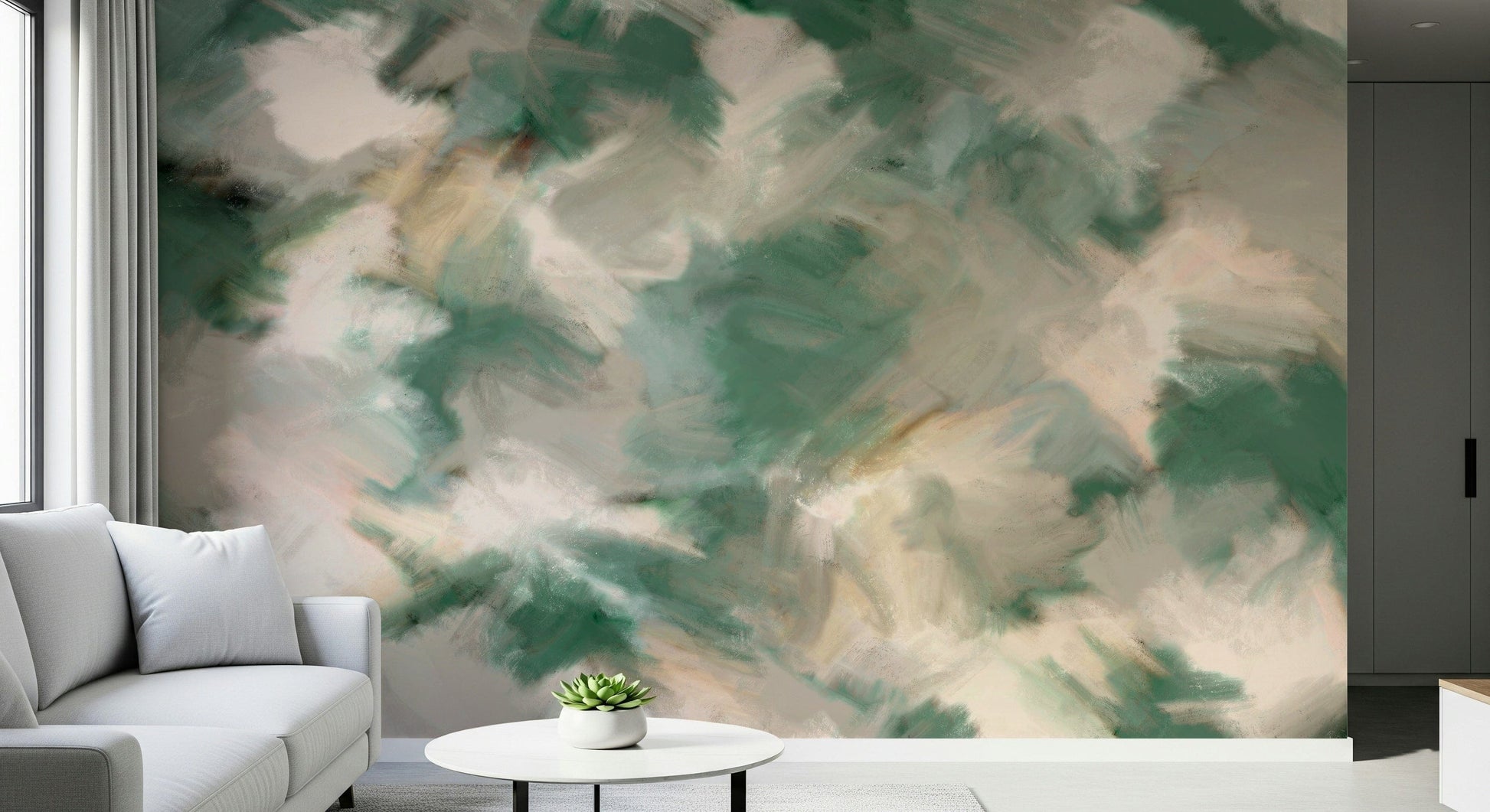 Ethereal Brushstrokes wallpaper mural in green and cream shown as a full-wall mural beside a grey sofa and round table